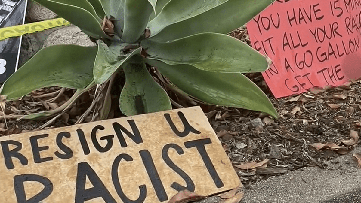 Protest signs outside the home of L.A. City Councilmember Kevin de Leon as calls intensify for his resignation and the resignation of fellow councilmember Gil Cedillo in response to racists comments caught on tape last year as redistricting lines for the City of Los Angeles were under consideration.