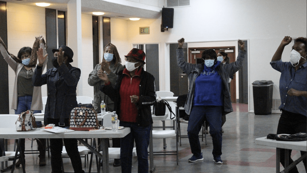 Community members cheer during a town hall event on Long Haul COVID hosted by the Center for Healthy Communities (CHC) at the University of California, Riverside on Nov. 30, 2022 at Ecclesia Christian Fellowship church in San Bernardino, CA.