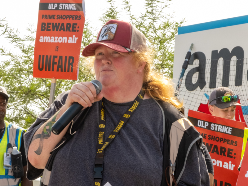 Sara Fee, a worker at KSBD, the Amazon air hub warehouse, speaks at the picket on October 22, 2022. The crowd booed as she recounted how workers recently received a one dollar raise and that she did not even notice a difference in her paycheck and was taxed more for her benefits.