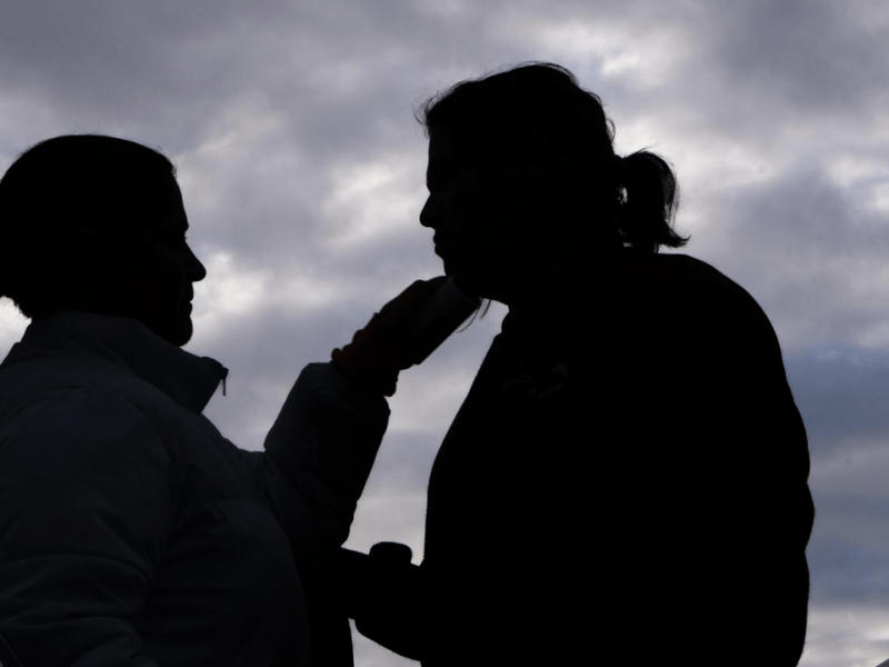 Nena Garcia uses a lint roller to remove dog fur from her son, Adam Garcia’s clothing before entering the Larson Justice Center in Indio for his court hearing on January 23, 2024. They arrived just after sunrise to ensure they had enough time to make it to court if they encountered any traffic or car trouble. Adam’s interaction with the criminal justice system leaves them feeling constantly afraid. Since his arrests in 2021, they spend almost every hour of the day together out of fear of Adam being rearrested.