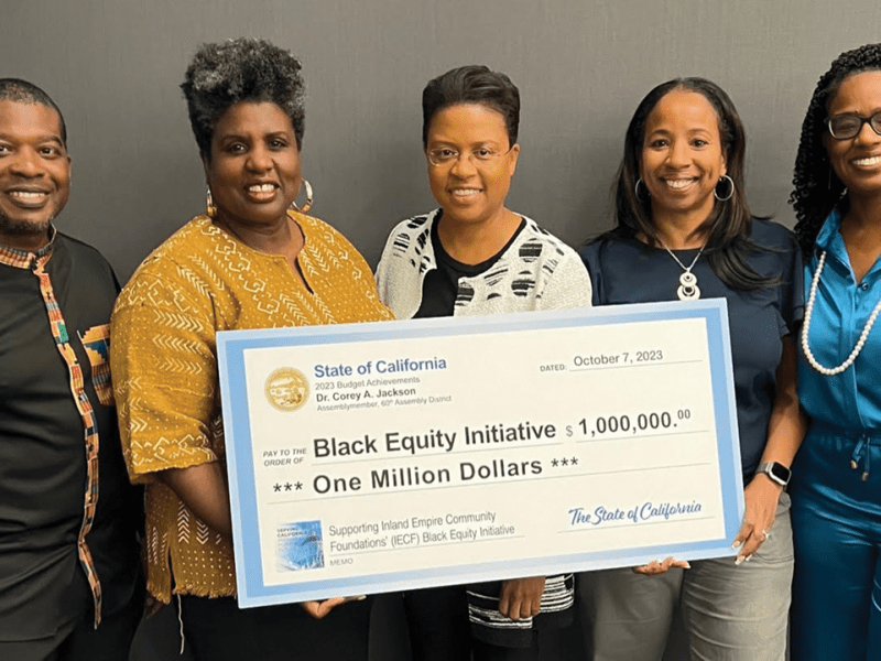 Assemblymember Corey Jackson presents a check for $1 million to the Black Equity Initiative of the Inland Empire, which has the IE Black Equity Fund at the Inland Empire Community Foundation. Grants from the Fund will continue supporting Black-led and serving organizations throughout the region. IECF staff and board members Nefertiti Long, Paulette Brown-Hinds, and Charee Gillins, join BEI leader Dina Walker.