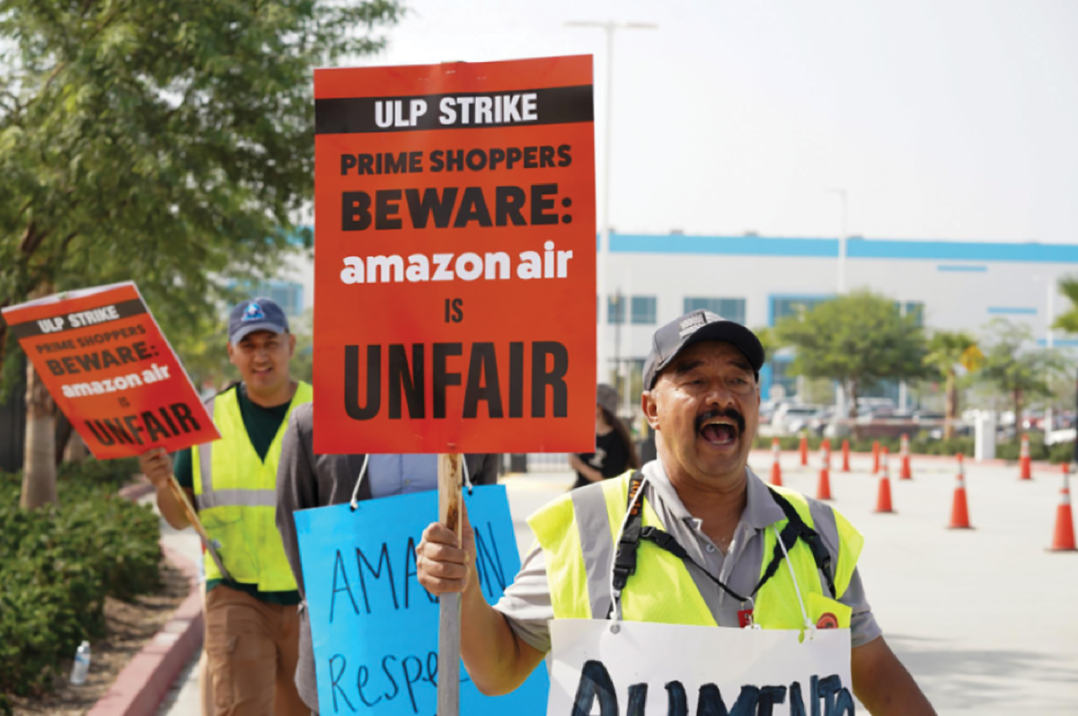 Amazon workers chant as they march the picket line in front of KSBD, the Amazon air hub warehouse on October 14, 2022.