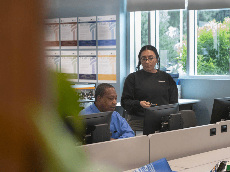 Richard Jerimiah Giles III, 58, works with a computer technician at Riverside Community College for the upcoming semester on April 4, 2024. After serving 28 years in prison he was released in February. He works daily at reintegrating into society by learning new skills and navigating technology.